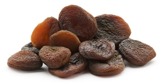 Group of dried natural Apricots isolated on white